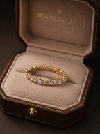 18K yellow gold Orbit Eternity Band bezel-set diamond wedding ring in JewelryRich signature dark brown octagonal velvet jewelry box — fine jewelry made to order