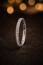 18K white gold thin minimal micro-pavé diamond wedding band with brilliant-cut GIA certified diamonds, dark luxury flat lay, JewelryRich