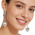 Model wearing 14K White Gold Diamond Heart Drop Hoop Earrings - JewelryRich
