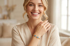 Woman wearing Teardrop Duet Cuff 18K gold bracelet with Swiss Blue Topaz – lifestyle photo