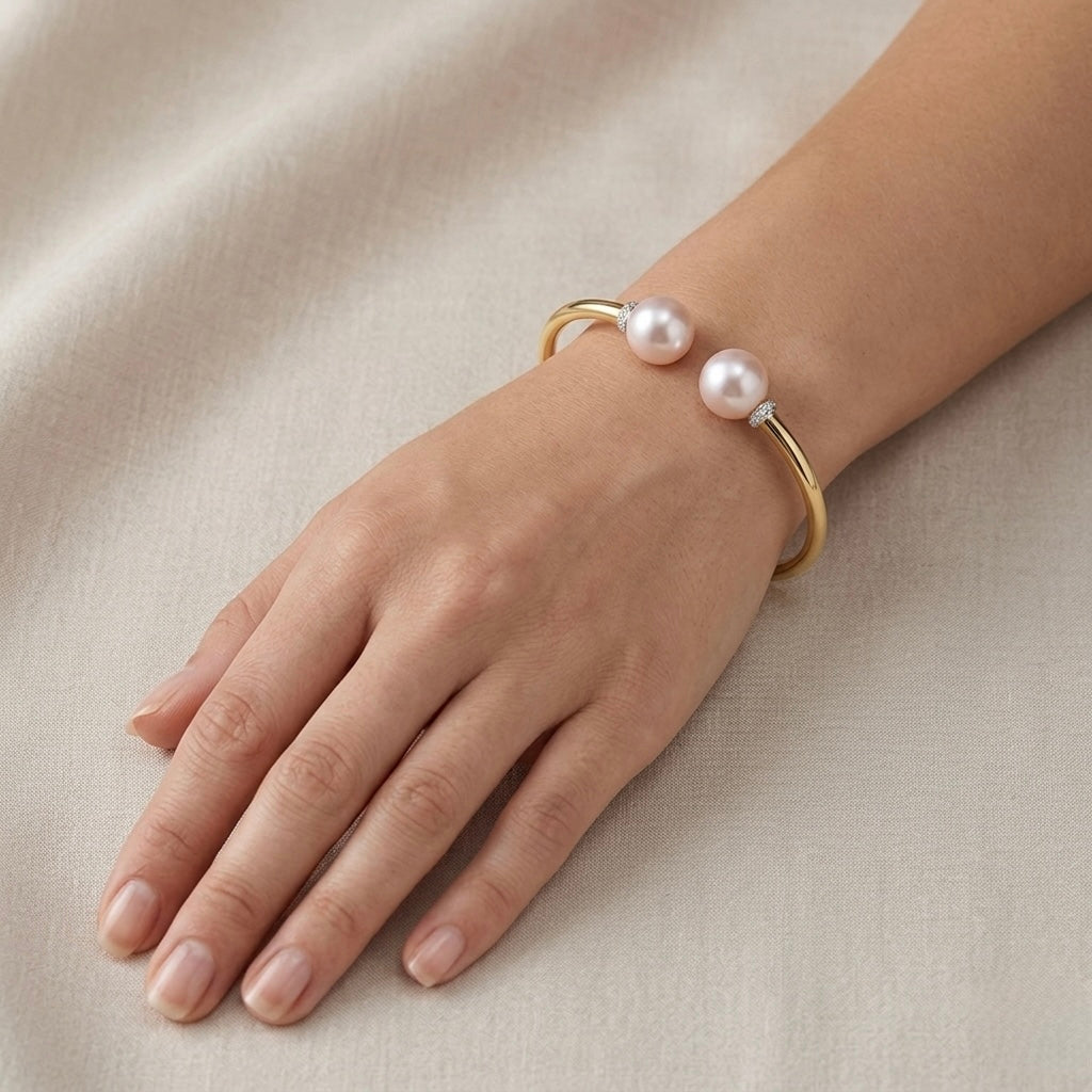 Pearl Duet Cuff 14K Yellow Gold freshwater pearl diamond bangle worn on wrist – lifestyle photo