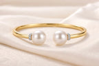 Pearl Duet Cuff 14K Yellow Gold two freshwater pearls with pavé diamond rondelle collar – flat lay on fabric