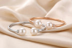 Pearl Duet Cuff 14K White Gold and Rose Gold freshwater pearl bangles – flat lay on silk fabric