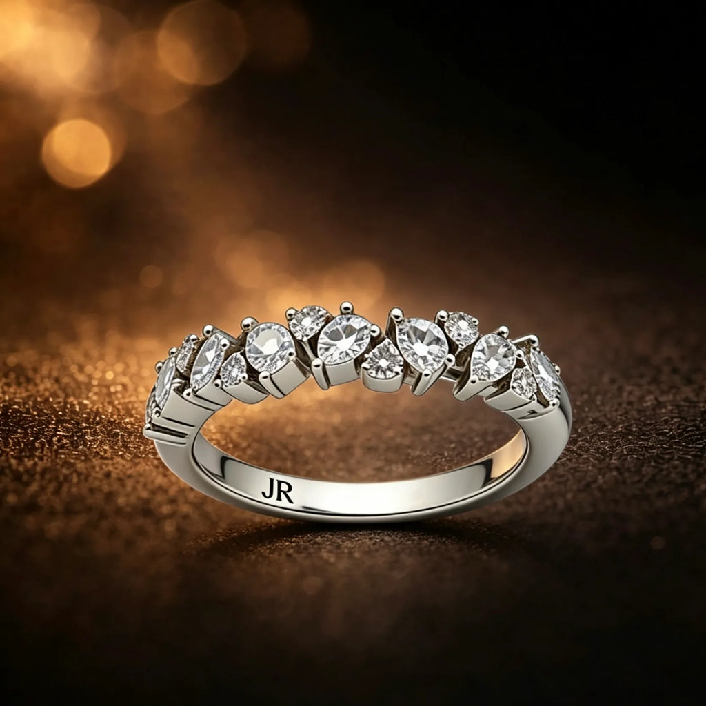 White Gold Multi-shape diamond band with round and pear cut stones in a unique wavy staggereed setting
