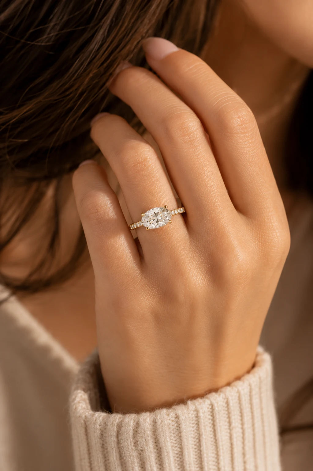 East-West oval diamond solitaire ring 18K yellow gold pavé band — lifestyle view wearing on hand — JewelryRich