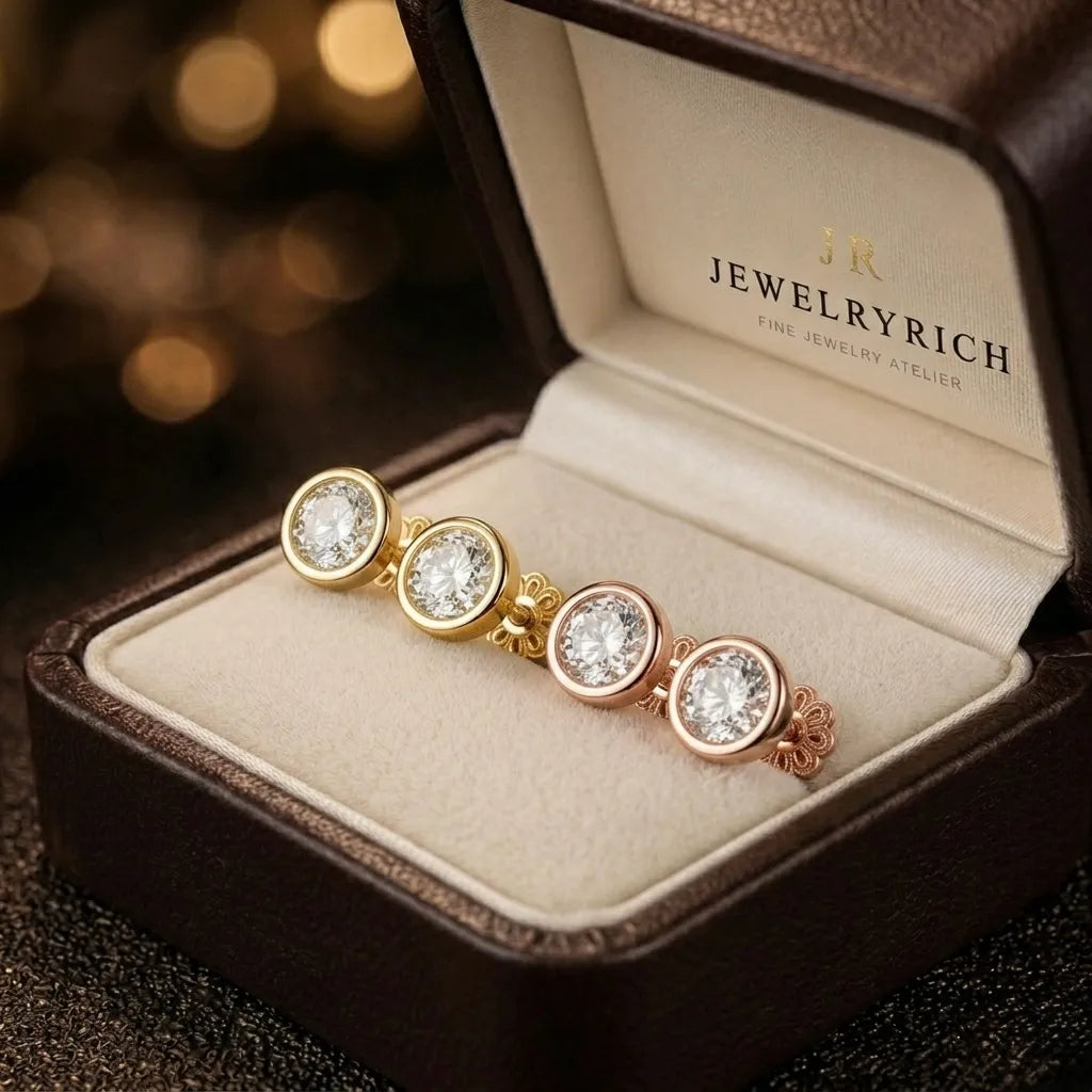Bezel-set diamond stud earrings in yellow gold, white gold, and rose gold displayed in JewelryRich gift box
