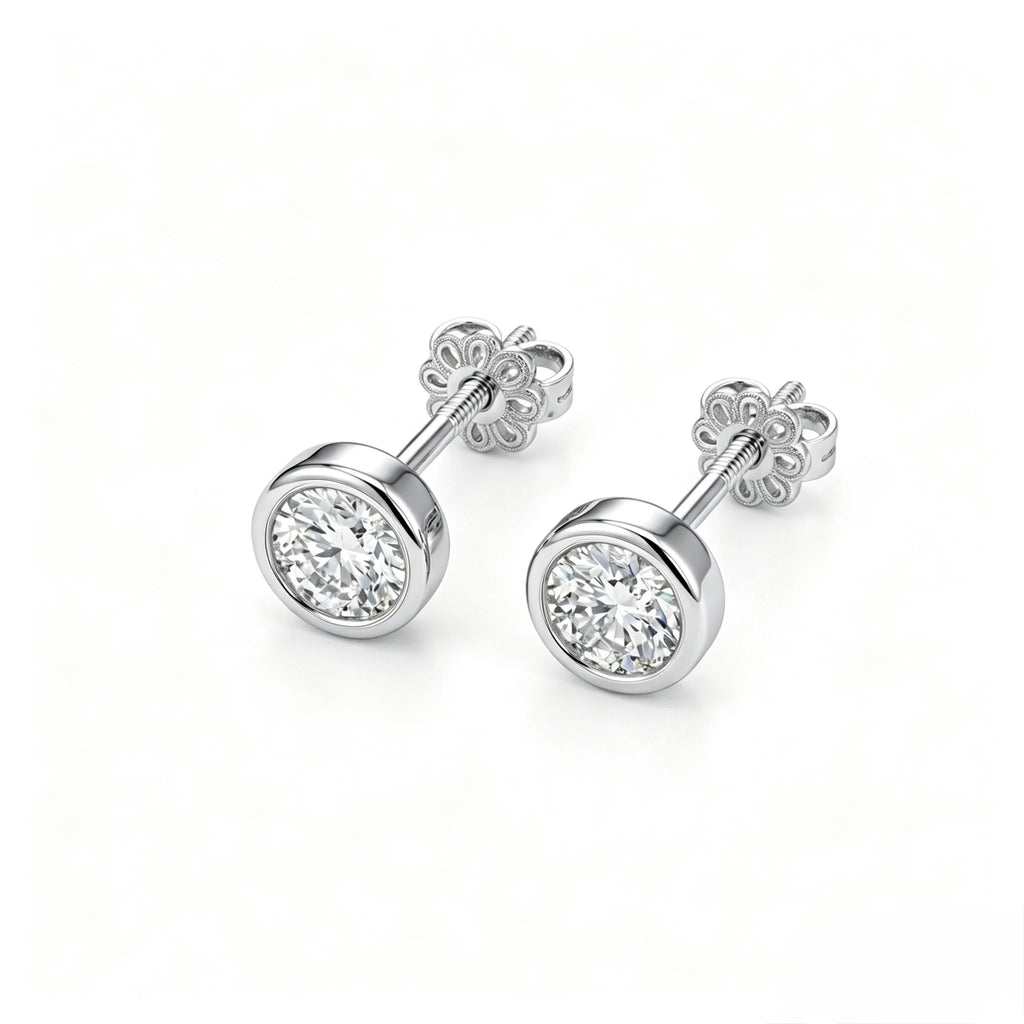 Pair of bezel-set diamond stud earrings in 18K white gold, front view on white background