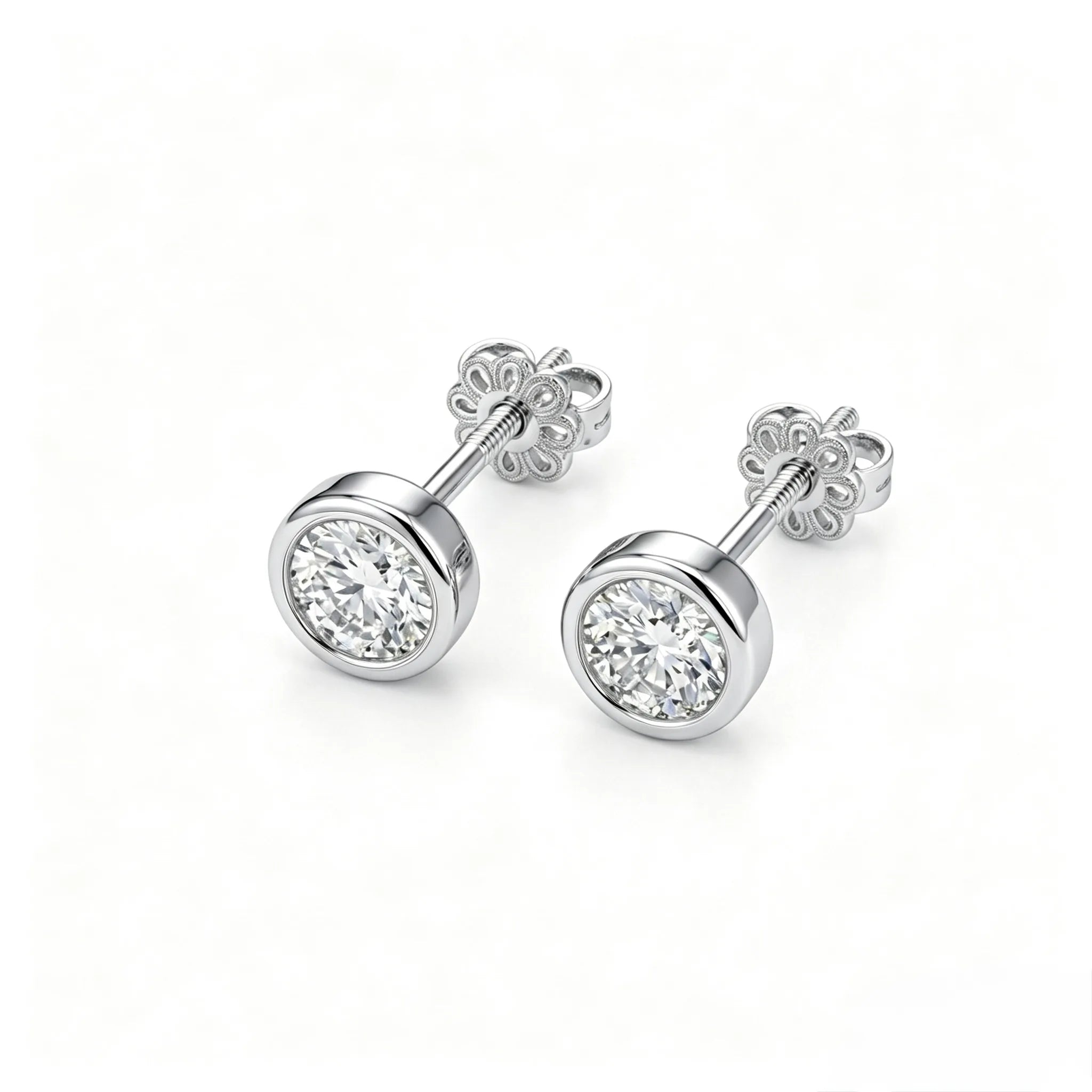 Pair of bezel-set diamond stud earrings in 18K white gold, front view on white background