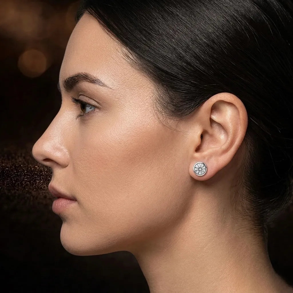 Model wearing bezel-set diamond stud earrings in 18K white gold, elegant side profile