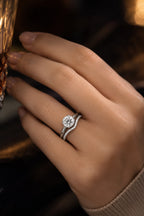 Hidden halo diamond bridal set side view worn on hand — engagement ring with contoured pavé band in 18K white gold — GIA certified — JewelryRich