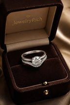 Hidden halo diamond engagement ring and contoured pavé wedding band bridal set overhead view in JewelryRich luxury gift box, 18K white gold