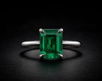 Emerald-cut natural green emerald solitaire ring in platinum, vivid Colombian green, four-prong setting, JewelryRich