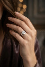 Three-stone emerald-cut diamond ring with baguette side stones, lifestyle editorial shot, 18K White Gold JewelryRich fine jewelry
