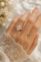 Oval hidden halo diamond engagement ring worn on hand, platinum 950 setting with vintage milgrain band, JewelryRich