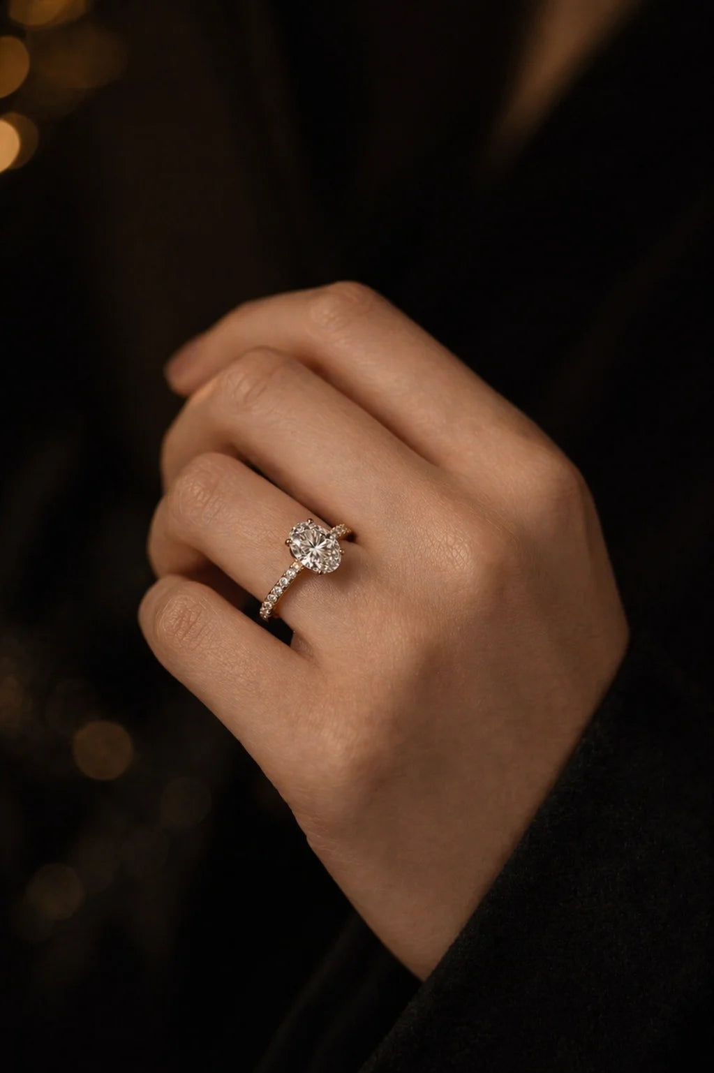 Oval solitaire diamond engagement ring worn on hand — slim Rose gold band elongating silhouette | JewelryRich